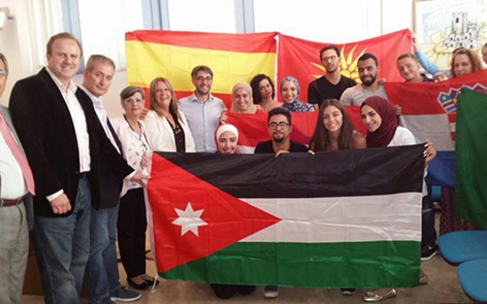 group photo with a the jordan flag in front 