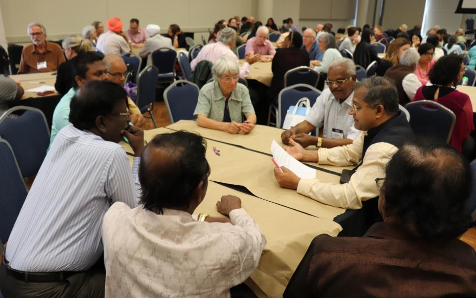 Participants participate in a World Cafe dialogue. 