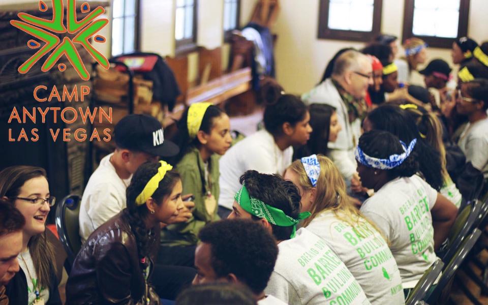 Diverse youth sit and talk with one another