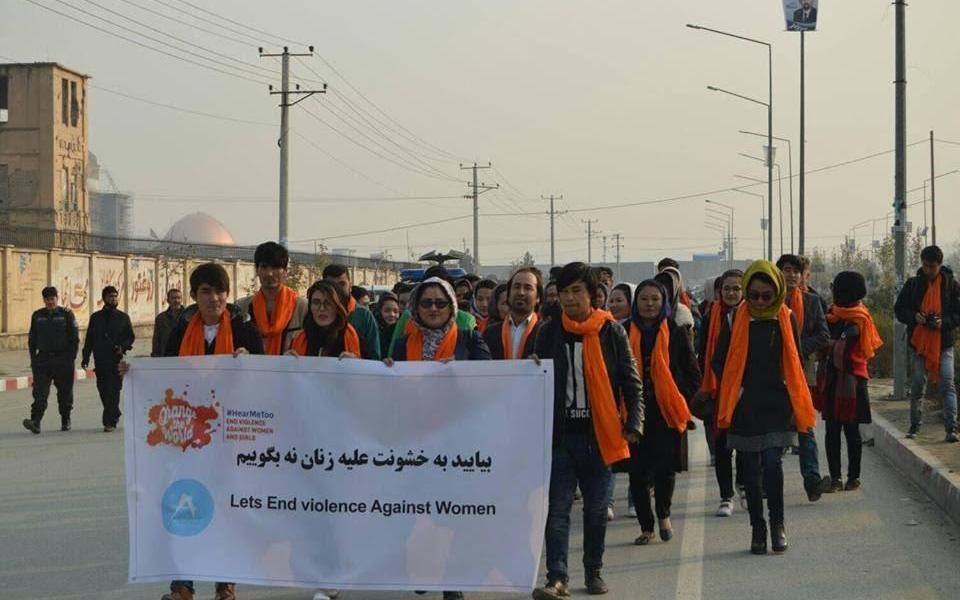 Photo: A group of people walking with a banner