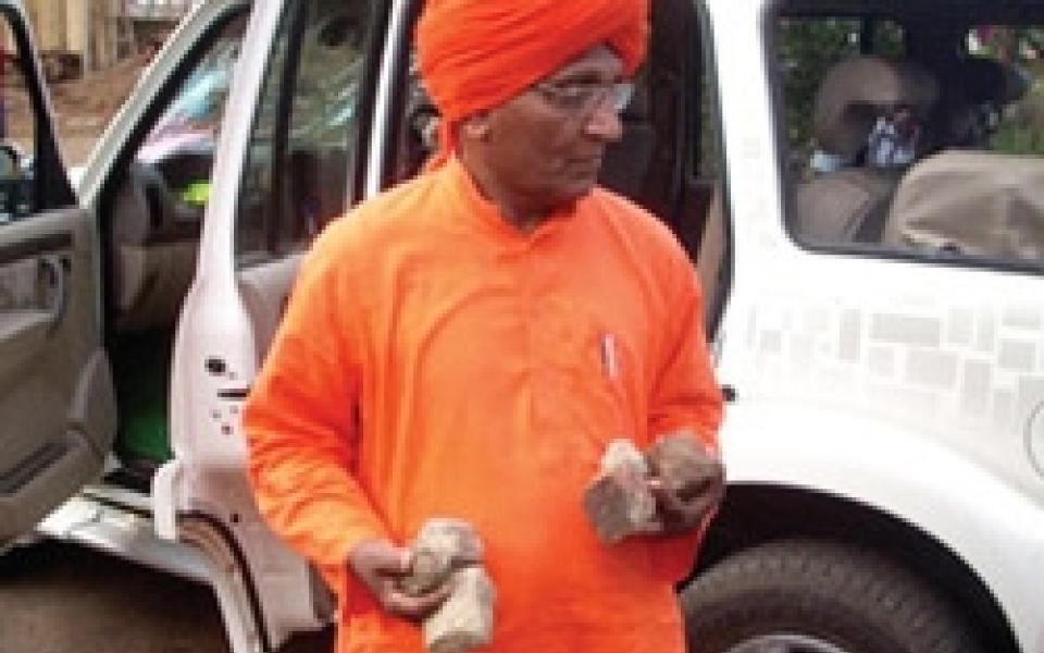 Swami standing next a car 