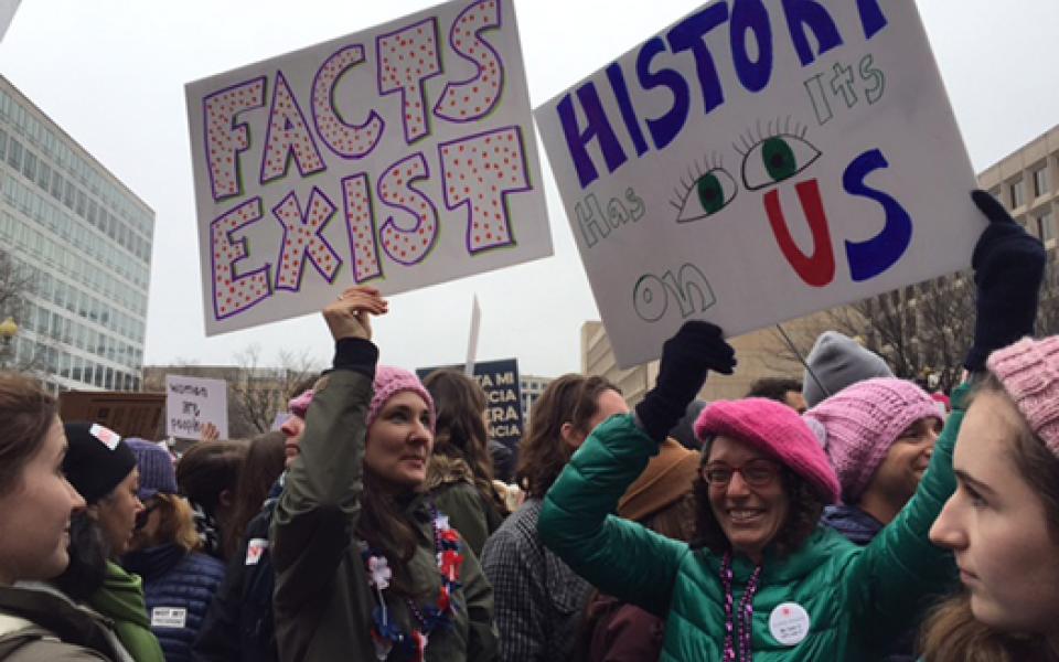 women holding posters up 