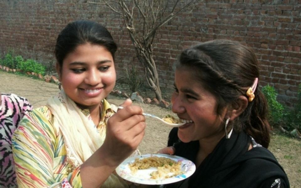 A women is feeding her fellow 