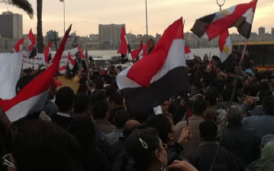 Egyptian protesting holding the Egyptian flag  