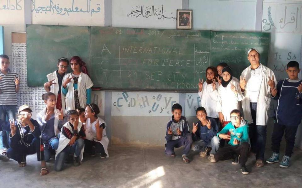 Children in a classroom with a whiteboard