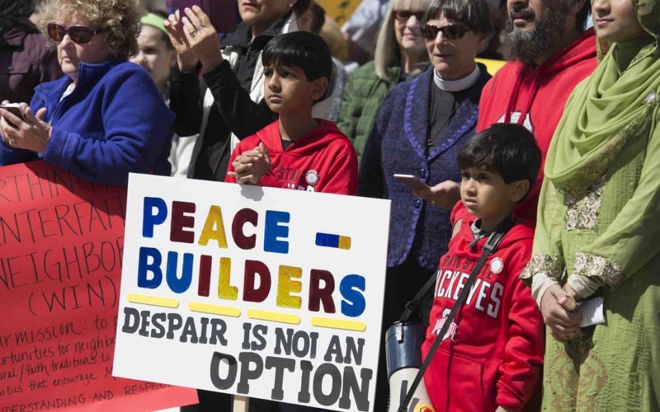 People holding signs of peace