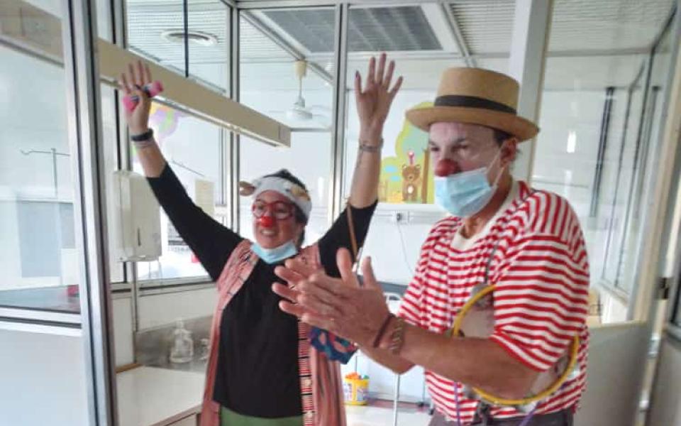 Photo: Members of the Sonrio CC dressed like clowns entertaining the children 