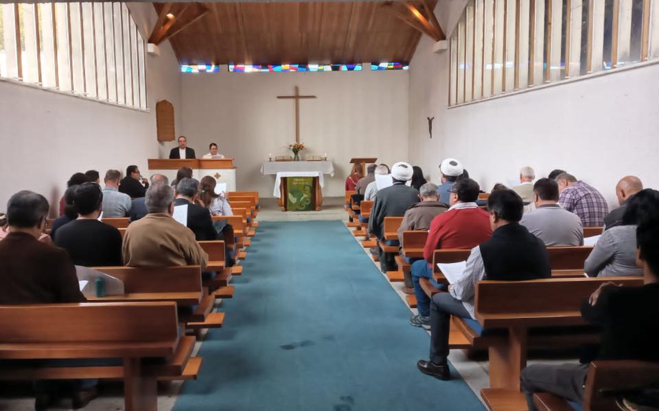 Photo: members praying. 